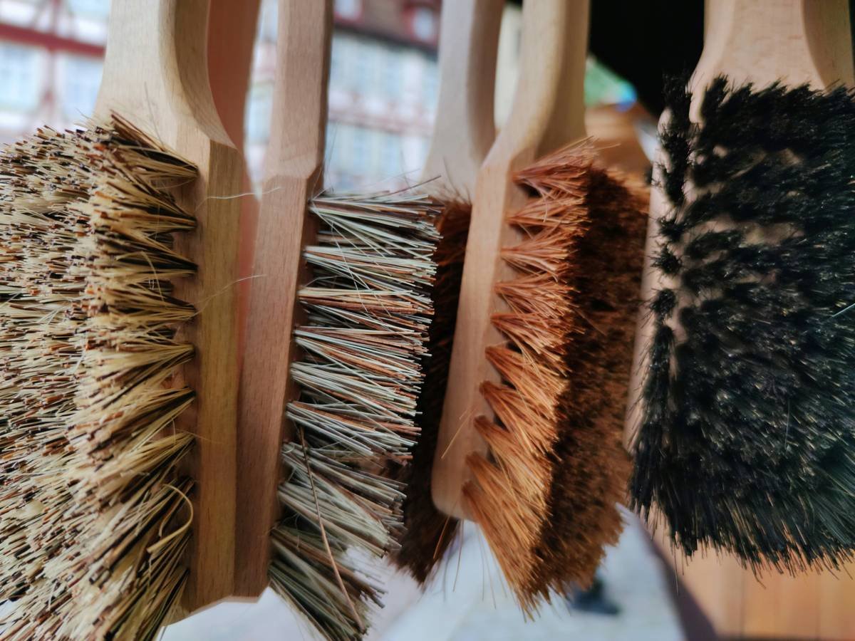 Side-by-side comparison: damaged hair from plastic brush vs healthy hair using nourishing brush with boar bristles