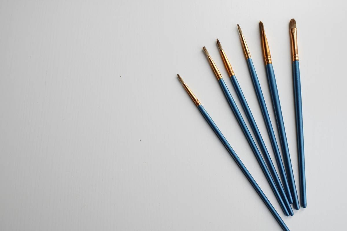 Close-up comparison of flexible-tip detangling styling tool vs traditional brush showing bristle flexibility